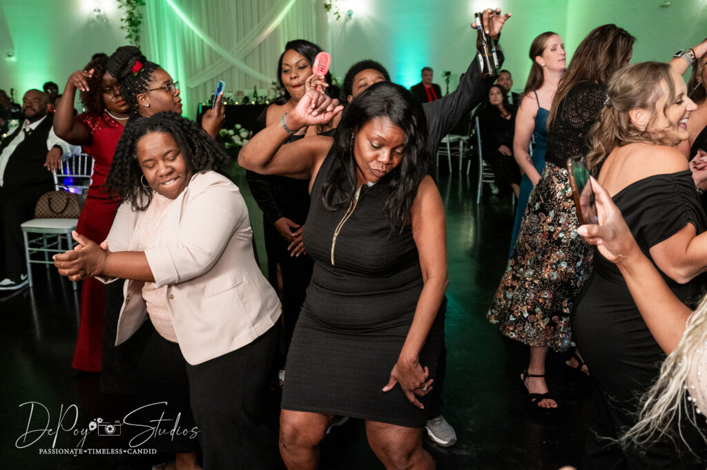 Wedding guests dancing under the glow of string lights at SoHo63 in Downtown Chandler.