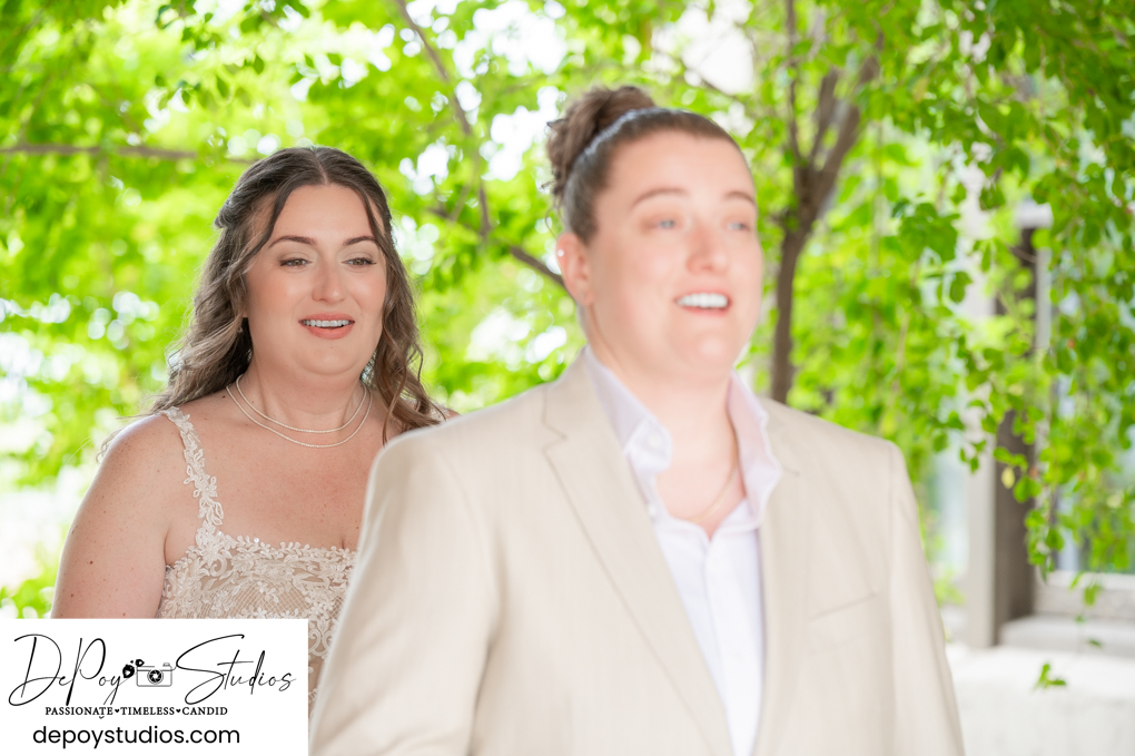same-sex couple first look at Secret Garden wedding venue